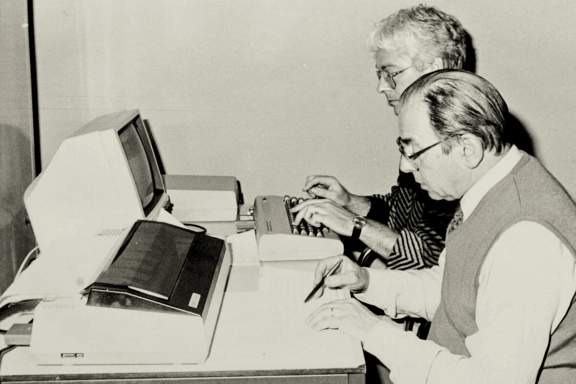 Foto: Ambtenaren aan het werk op de Commodore computer en aan de matrix printer.